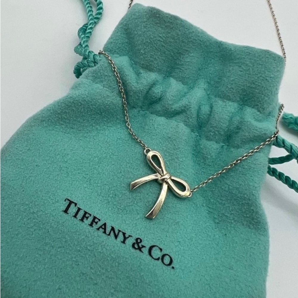 Authentic Tiffany & Co 925 Sterling silver bow necklace. Includes pouch. 16” L